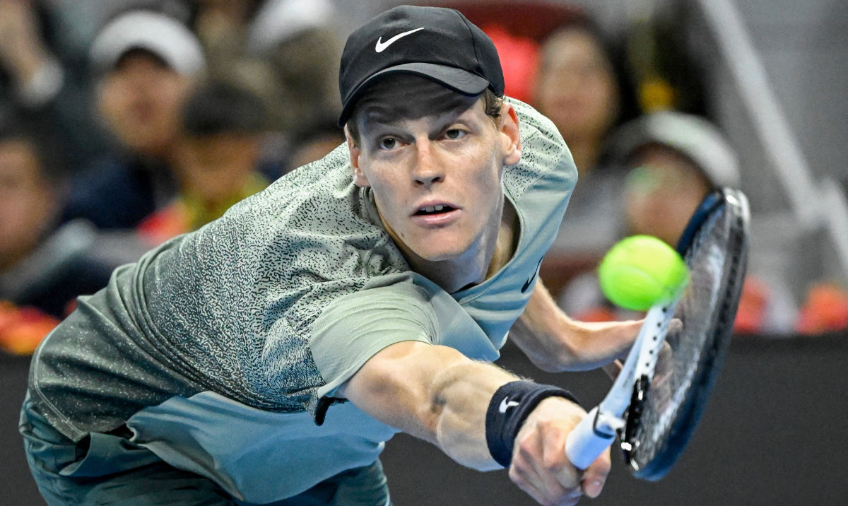 Italy's Jannik Sinner hits a return to China's Bu Yunchaokete during their men's singles semifinal at the China Open tennis tournament in Beijing on Tuesday. (AFP)