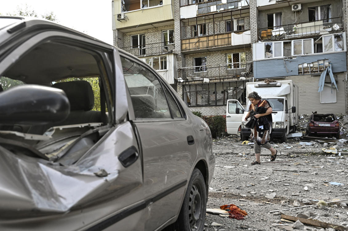 A woman walks next to her apartment building damaged by a Russian air strike, amid Russia's attack on Ukraine, in Zaporizhzhia, Ukraine October 1, 2024. (Reuters)