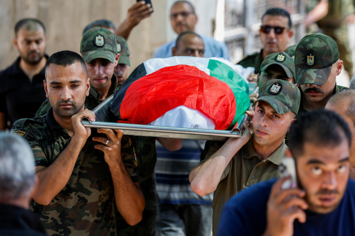 Members of Palestinian security forces carry the body of a Palestinian from Gaza killed in Jericho as Iran fired a salvo of ballistic missiles against Israel, during his funeral in Jericho, in the West Bank on Oct. 2, 2024. (Reuters)