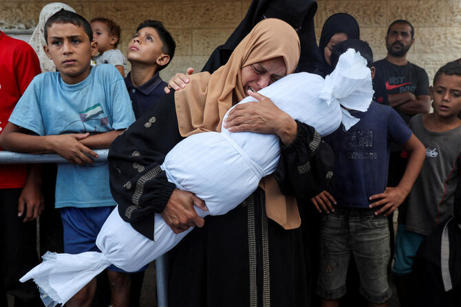 A relative holds the body of a a Palestinian child from al-Durrah family, who was killed in an Israeli strike, amid the Israel-Hamas conflict, at Al-Aqsa Martyrs Hospital in Deir Al-Balah in the central Gaza Strip. (File/Reuters)