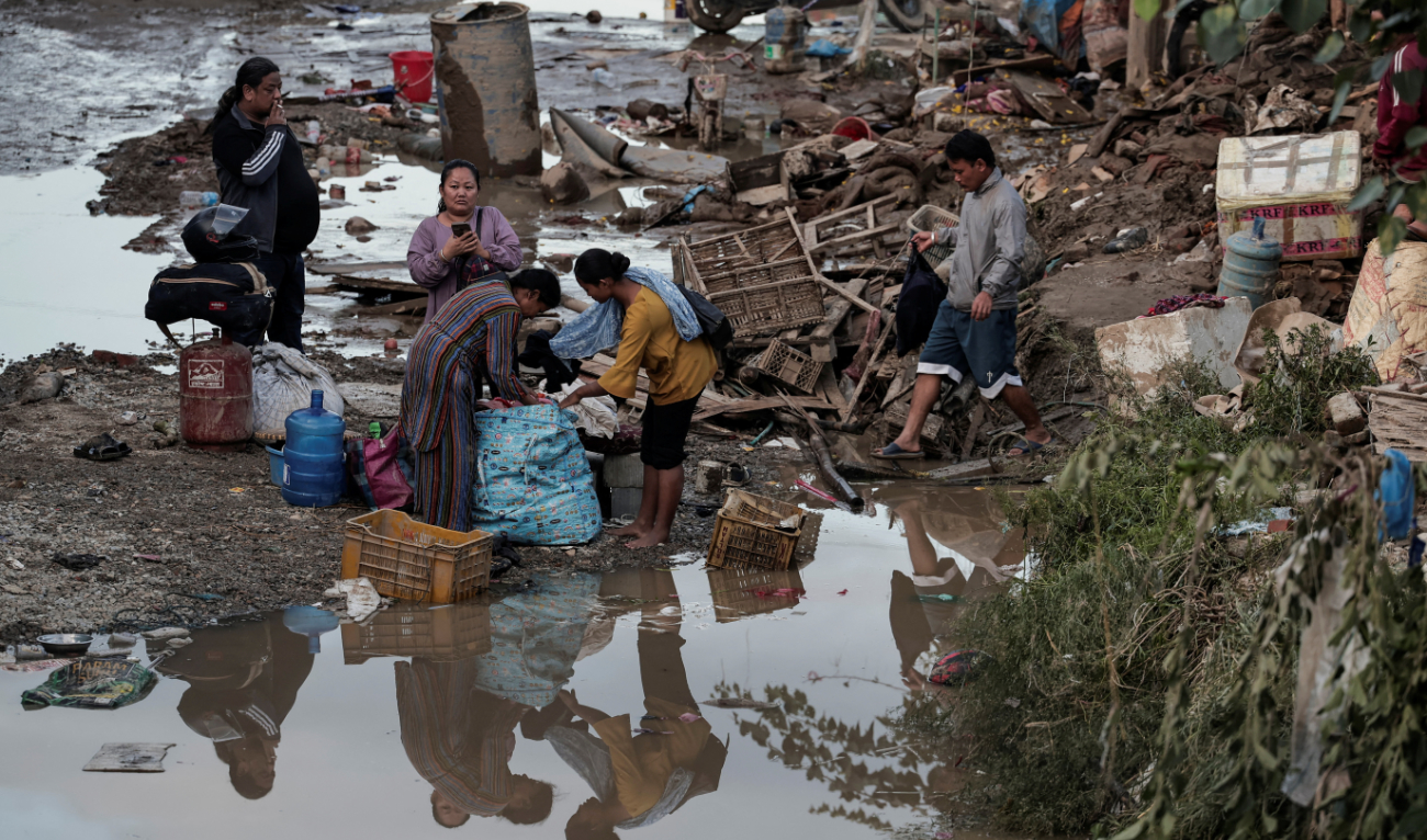 People salvage their belongings from the streets after the Bagmati River in Kathmandu, Nepal, overflowed on Sept. 29. (Reuters)