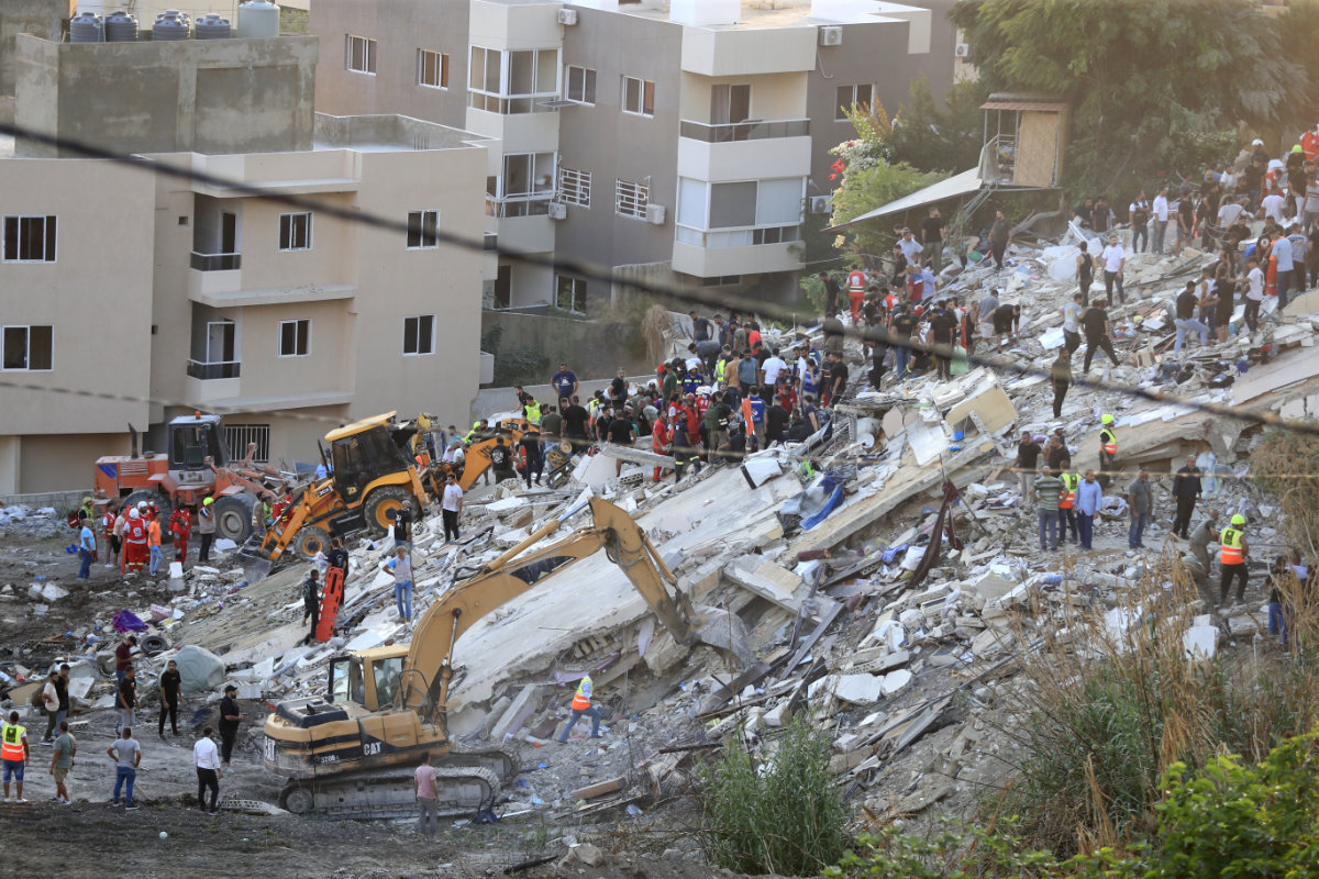 People and rescue teams search for victims after an Israeli airstrike hit two adjacent buildings, in Ain el-Delb neighbourhood east of the southern port city of Sidon, Lebanon, on Sept. 29, 2024. (AP)