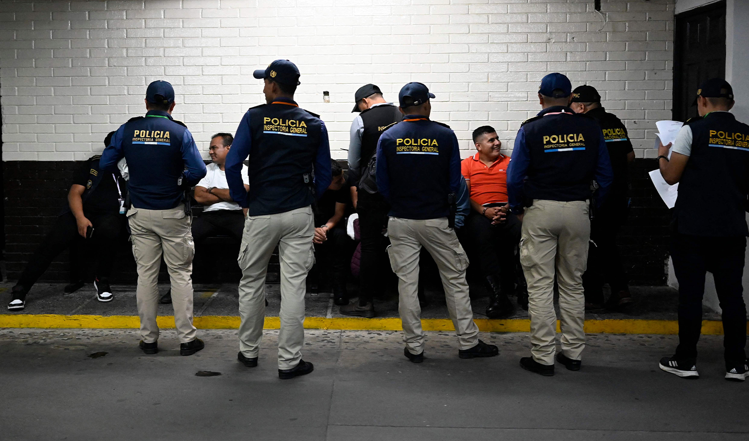 Members of the General Inspectorate of the Guatemalan National Civil Police guard arrested police members on arrival at a court hearing, in Guatemala City on October 1, 2024. (AFP/File)