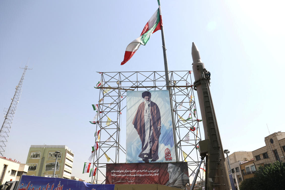 Above, an Iranian missile system is displayed next to a banner with a picture of Iran’s Supreme Leader Ayatollah Ali Khamenei in a street in Tehran on Oct. 2, 2024. (WANA via Reuters)