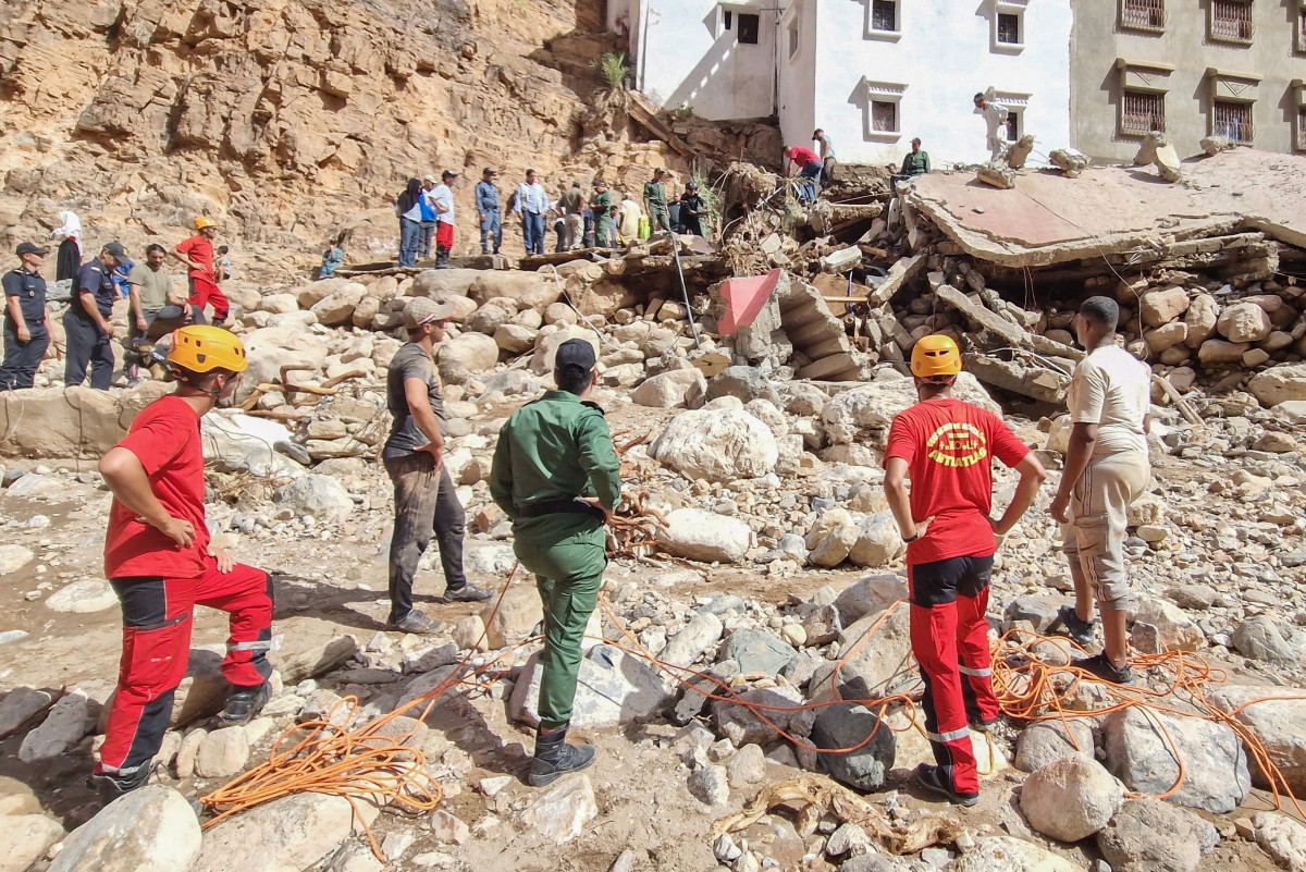 Members of Morocco's Auxiliary Forces and Civil Protection search the rubble for missing persons in a flood-devastated area of Tamanart in the Tata province on September 8, 2024.(AFP)