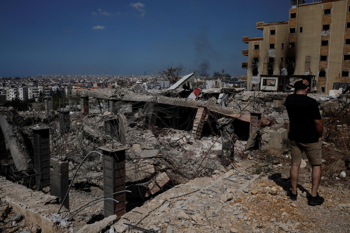 A man stands amid the damage caused by Israeli airstrikes, as smokes rises over Beirut southern suburbs at Choueifat district, in Beirut on Oct. 3, 2024. (Reuters)