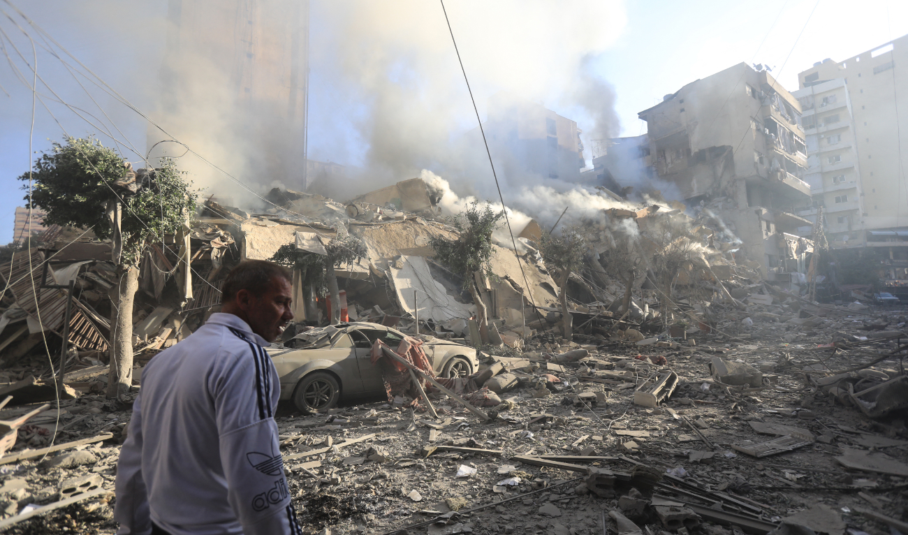 A man walks amid the rubble of a building levelled in an overnight Israeli airstrike that targeted the neighbourhood of Moawwad in Beirut's southern suburbs on October 3, 2024. (AFP/File)