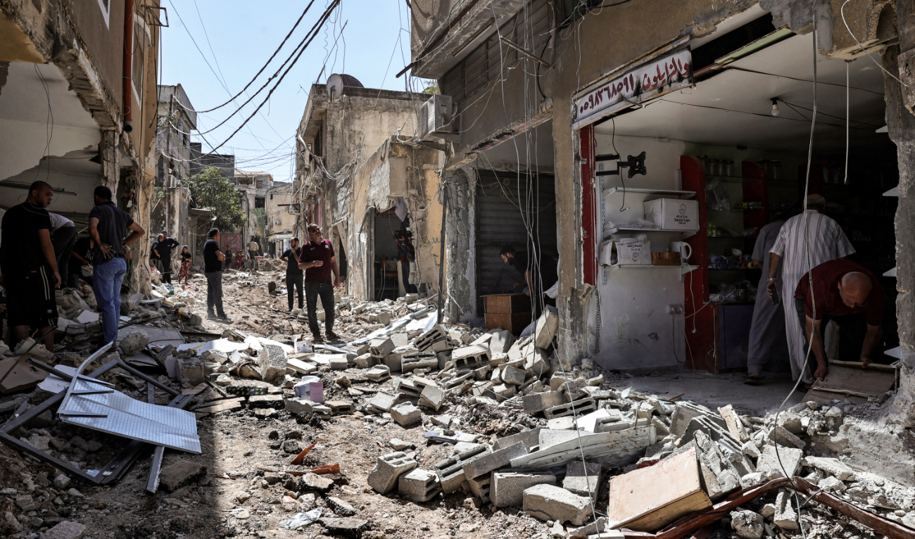 People inspect damage to buildings along a street after an Israeli army raid at the Nur Shams camp for Palestinian refugees, near Tulkarm in the north of the occupied West Bank, on September 12, 2024. (AFP/File)