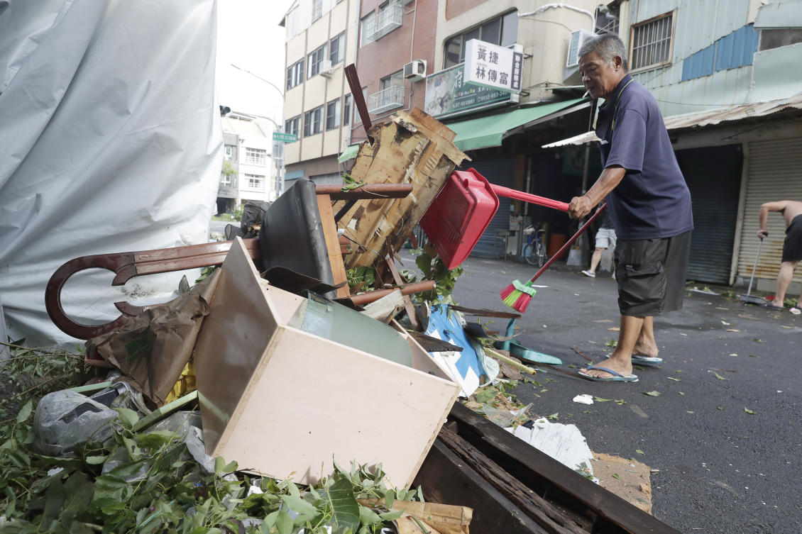 Typhoon Krathon hit land in the southwestern city of Kaohsiung, inundating streets, blowing out the windows of some buildings and scattering debris amid record-breaking winds. (AP)