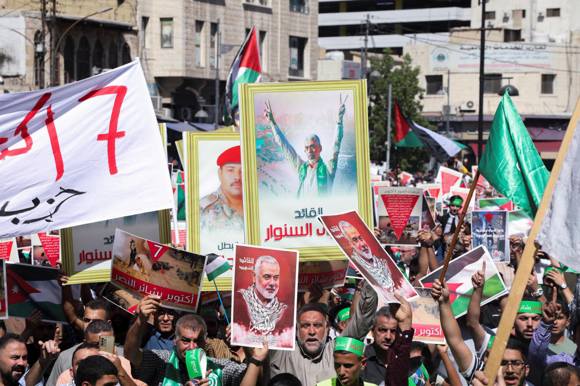 Demonstrators carry signs and flags during a protest in support of Lebanon and Gaza, amid the Israel-Hamas conflict and ongoing hostilities between Israel and Hezbollah, in Amman, on Oct. 4, 2024. (Reuters)