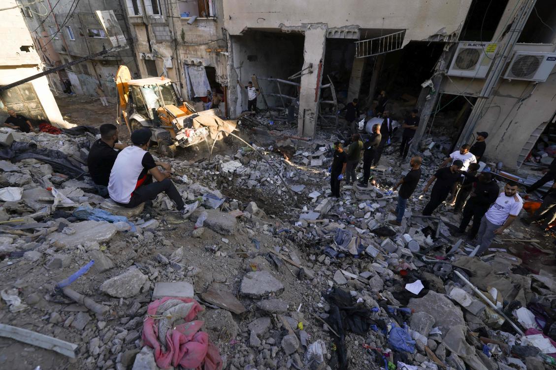 Palestinians inspect the damage at the site of an overnight Israeli airstrike on the Tulkarem refugee camp in the northern occupied West Bank on Oct. 4, 2024. (AFP)