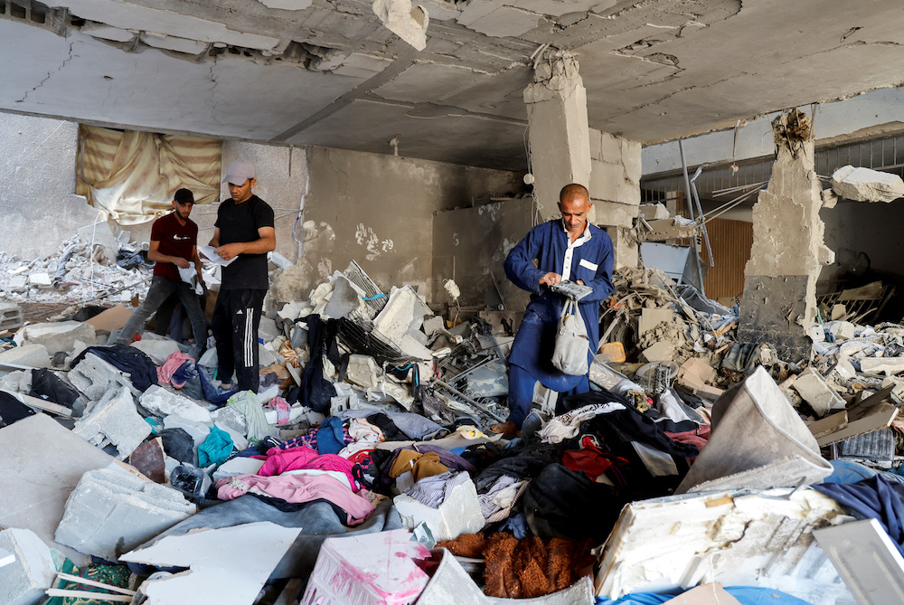 Palestinians inspect the damage at the site of an Israeli air strike in Tulkarm camp, in Tulkarm, in the Israeli-occupied West Bank, Oct. 4. (Reuters)