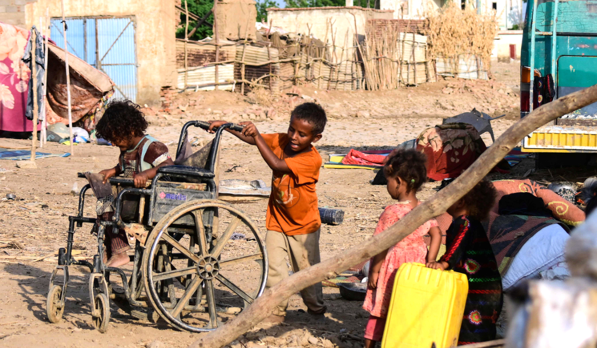 Children play on a street in Tokar in the Read Sea State on Thursday following recent heavy flooding in eastern Sudan. (AFP)