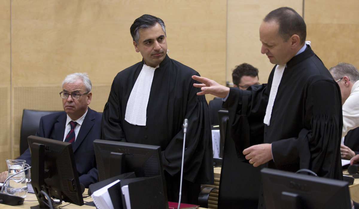 Ahmad Sadeq Al Gehani (L), Payam Akhavan (C) and Phillippe Sands (R), representatives of Libya, are seen in the International Criminal Court (ICC) before a public hearing on Libya's challenge to the admissibility of the case against Saif Al-Islam in The Hague on Tuesday. (Reuters)