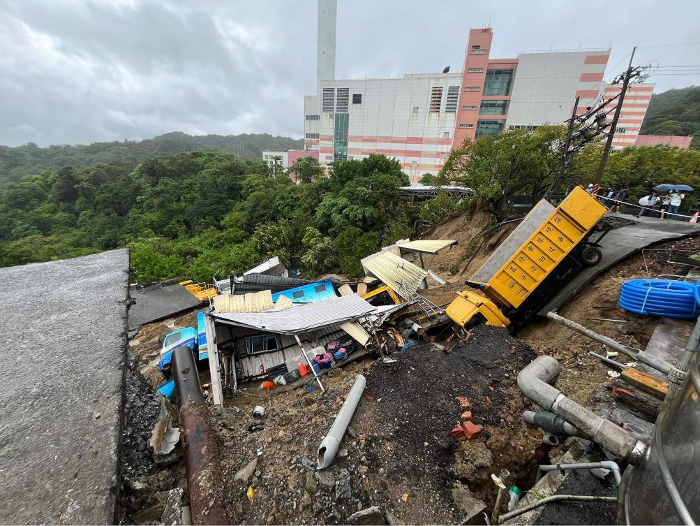 Above, public utility vehicles are trapped in a landslide near Keelung City’s Bureau of Environmental Protection, which was triggered by heavy rainfall after Typhoon Krathon swept across the island. (Taiwanese city councilor Chen Yi via AFP)