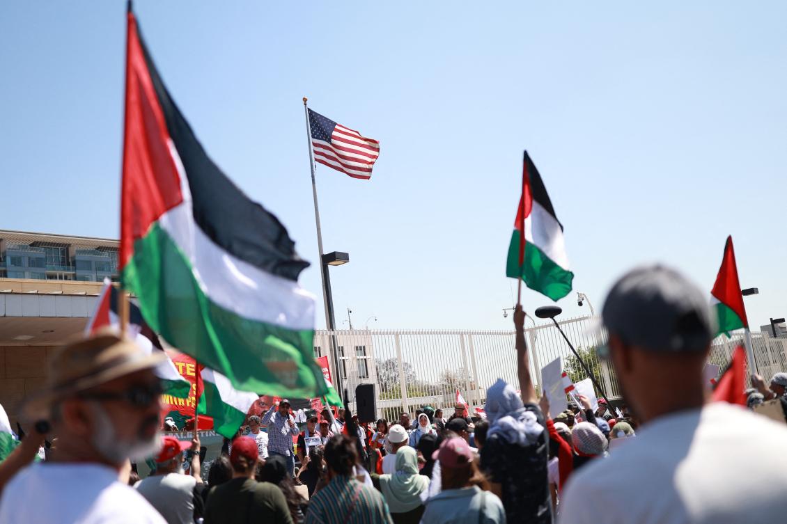 Pro-Palestinian protestors wave Palestinian flags during a demonstration against Israel's attacks on Lebanon and the ongoing war between Israel and Hamas militants in the Gaza Strip organised by the South African BDS Coalition outside the US Consulate in Johannesburg. (AFP)