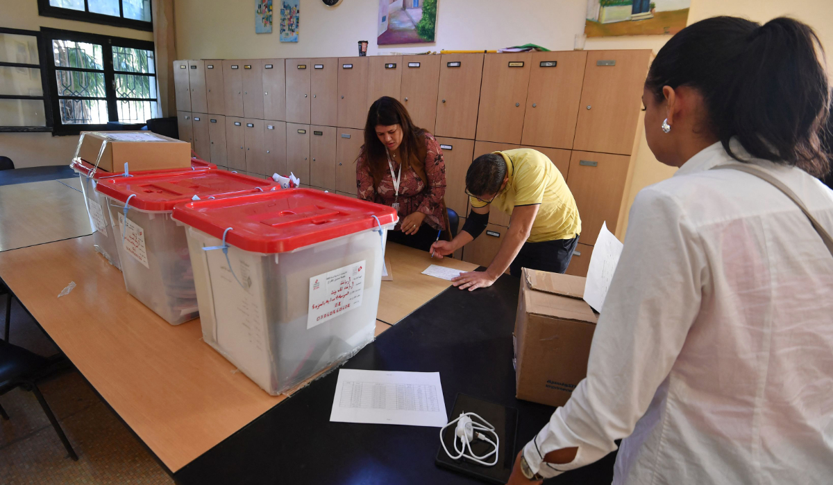 Election officials prepare a polling station near Tunis on Saturday. (AFP)