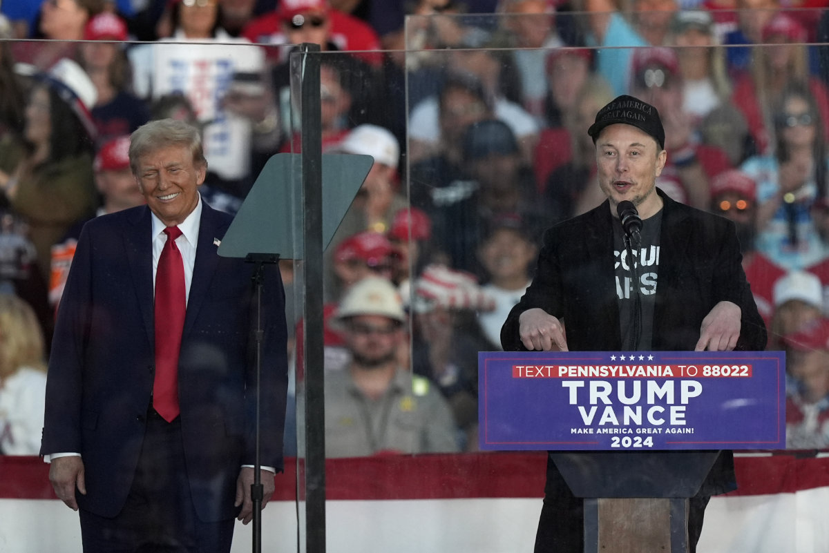 Republican presidential nominee former President Donald Trump listens as Elon Musk speaks during a campaign rally at the Butler Farm Show on Oct. 5, 2024, in Butler, Pennsylvania. (AP)