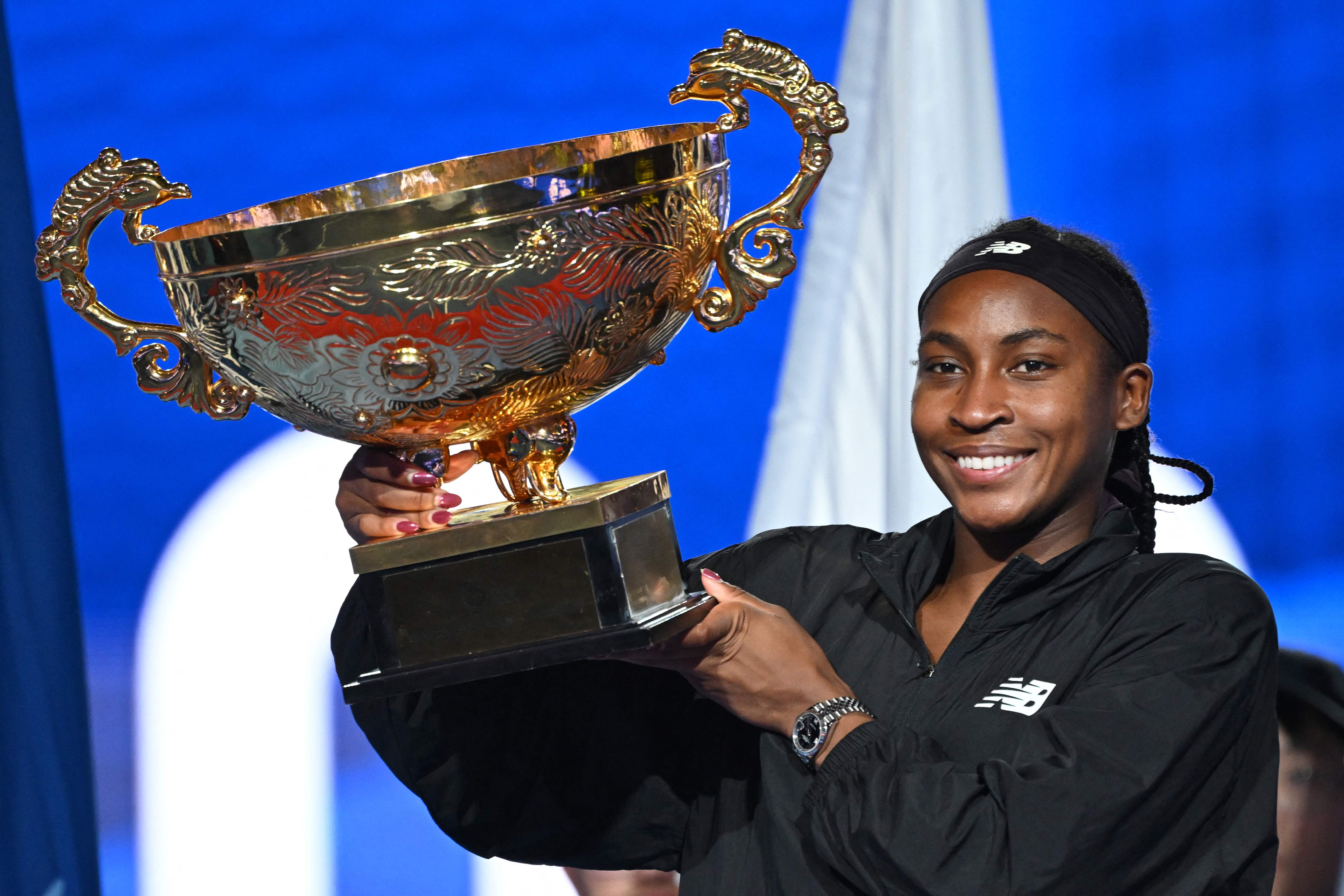 TUSA's Coco Gauff celebrates with the trophy after winning the women's singles final match against Czech Republic's Karolina Muchova at the China Open tennis tournament in Beijing on Sunday. (AFP)