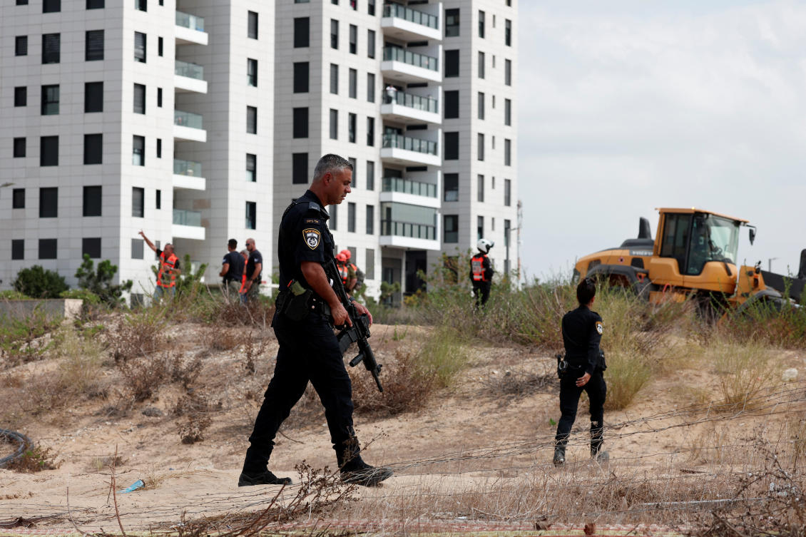 Israeli police officers work at the scene of where a projectile landed, after Hamas' armed wing said it attacked Tel Aviv with missile salvo, amid the ongoing Israel-Hamas conflict, in Holon, Israel. (File/Reuters)