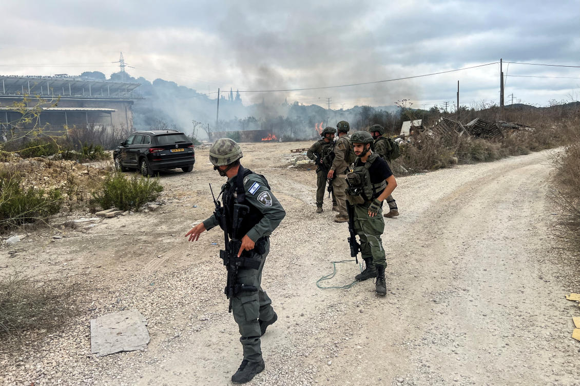Israeli border police officers attend the scene where a rocket, fired from Lebanon, landed in Maalot, northern Israel, October 7, 2024. (Reuters)