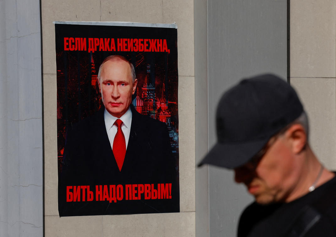 A man walks past a poster of Russian President Vladimir Putin, which was put up by activists to mark Putin’s 72nd birthday, in Donetsk, Russian-controlled Ukraine, Oct. 7, 2024. (Reuters)