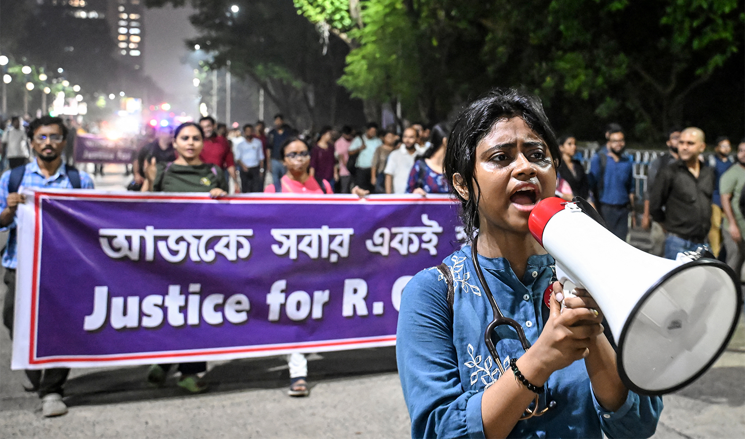 Activists and medical professionals shout slogans during a protest march to condemn the rape and murder of a doctor, in Kolkata on October 4, 2024. (AFP)