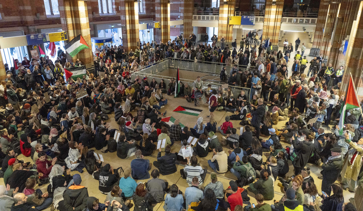 Pro-Palestinian demonstrators chant slogans during a sit-in at Central Station after a pro-Israeli commemoration marking the anniversary of the October 7, 2023, Hamas attack, in Amsterdam, Netherlands, Monday, Oct. 7, 2024. (AP)