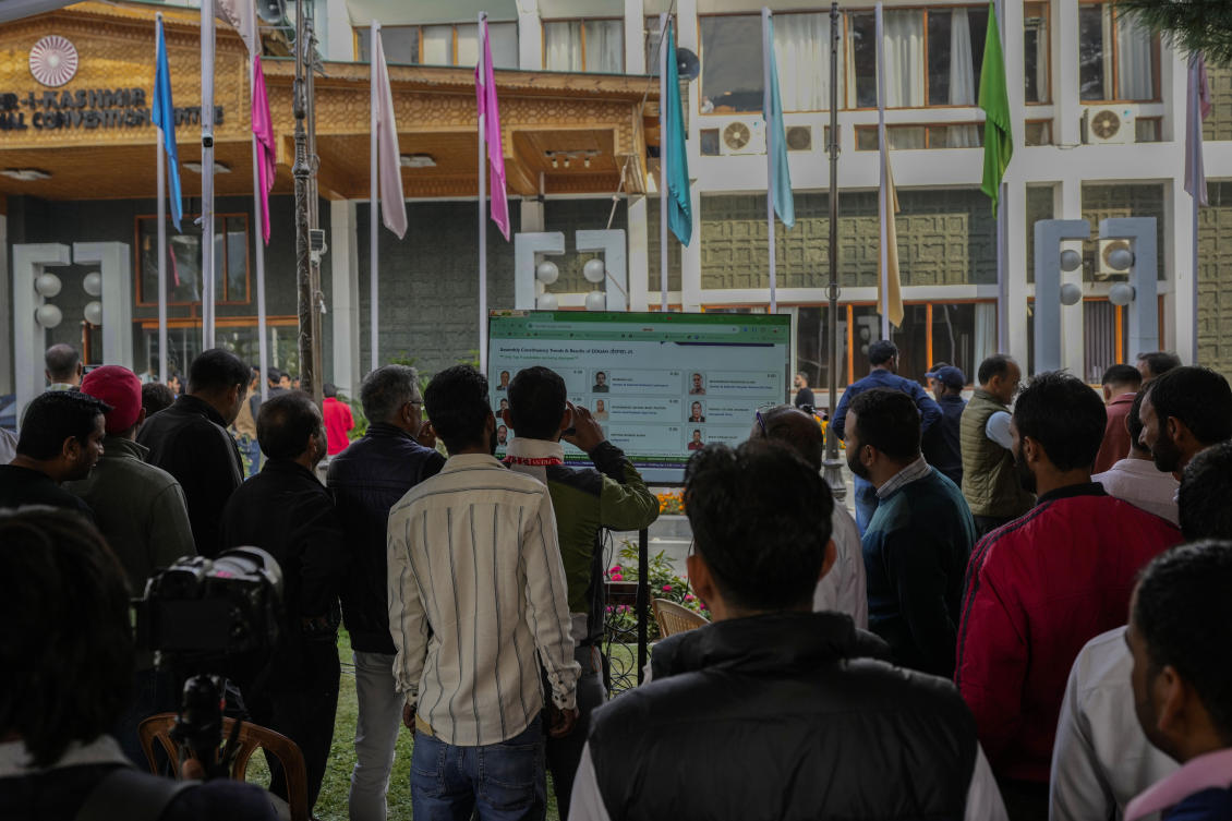 Party representatives and others watch updates outside a counting center as officials count the votes in the recent election for a local government in Indian-controlled Kashmir on Oct. 8, 2024. (AP)