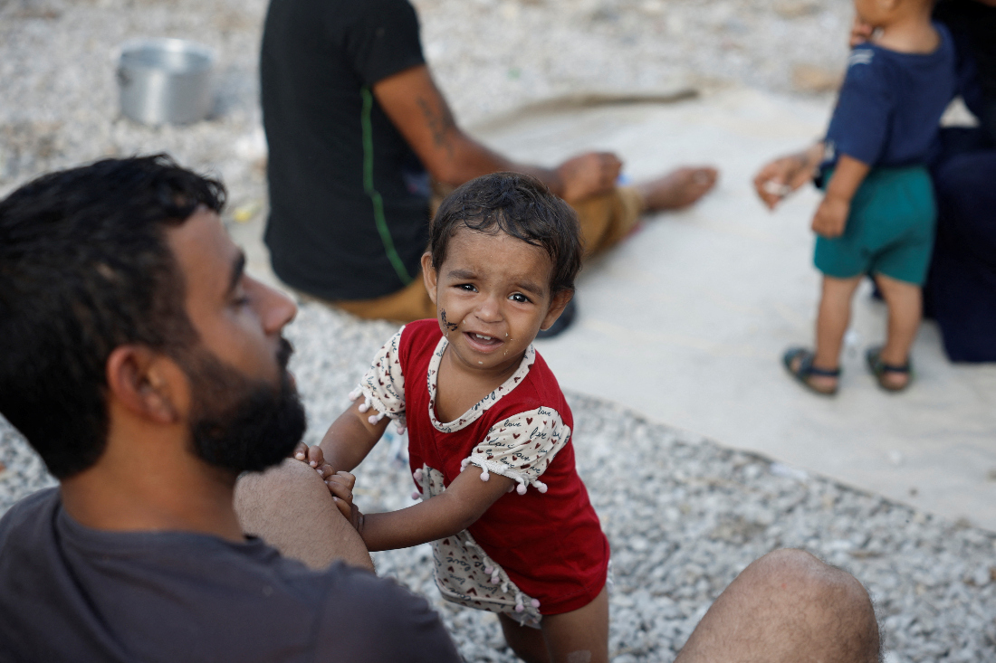 A child looks on while families sit in their temporary shelter in a park in the centre of the city, amid the ongoing hostilities between Hezbollah and Israel, in Beirut, Lebanon. (Reuters)