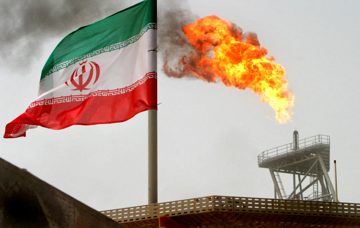 Above, a gas flare on an oil production platform is seen alongside an Iranian flag in the Gulf on July 25, 2005. (Reuters)