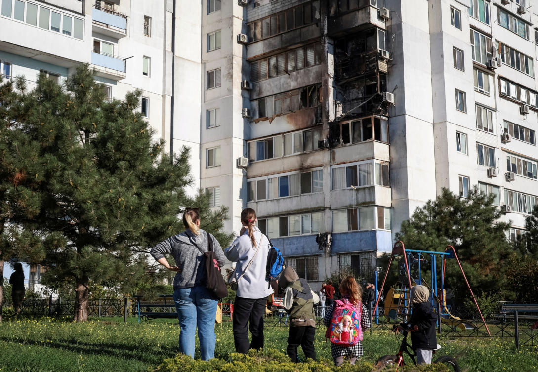 Locals stand at the site of a Russian drone strike, amid Russia’s attack on Ukraine, in the city of Chornomorsk, Odesa region on Oct. 8, 2024. (Reuters)