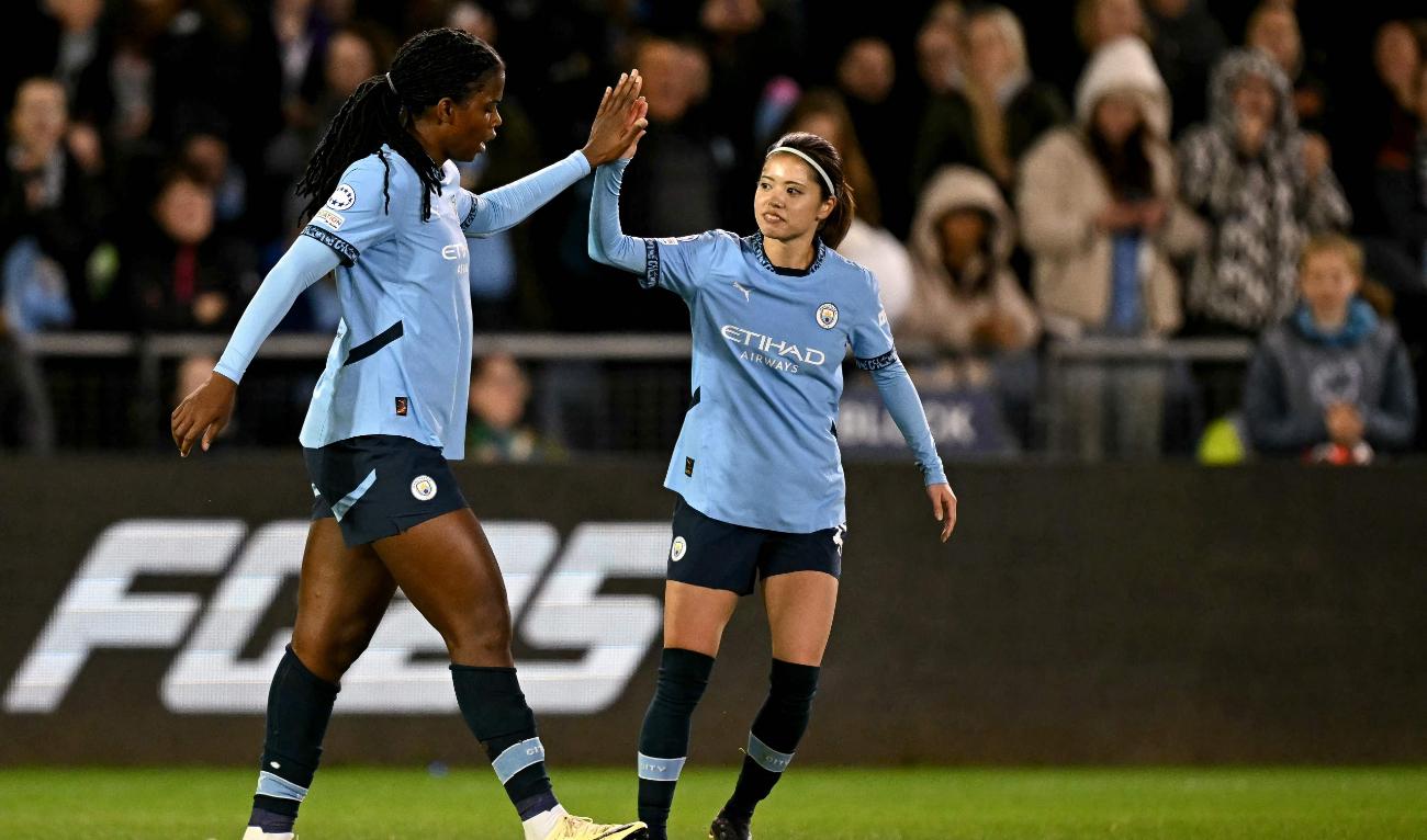 Manchester City's Jamaican striker #21 Khadija Shaw celebrates scoring the team's second goal alongside Manchester City's Japanese midfielder #25 Yui Hasegawa (R) during the UEFA Women's Champions League Group D football match between Manchester City and Barcelona at the Joie Stadium in Manchester on October 9, 2024. (AFP)