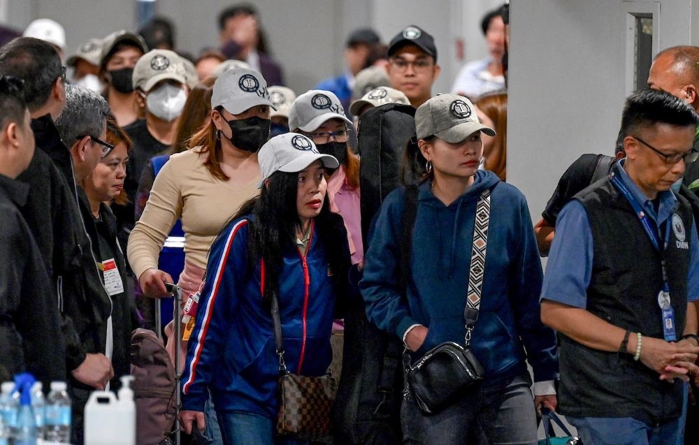 Philippine nationals arrive at Manila’s international airport on Oct. 18, 2023, after they were repatriated from Israel. (AFP)