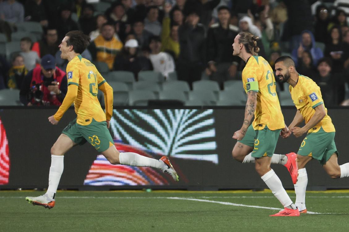 Australia’s Craig Goodwin, left, celebrates after scoring his team’s second goal during the World Cup 2026 Group C qualifying match against China at Adelaide Oval, Adelaide, Australia, Oct. 10, 2024. (AP)