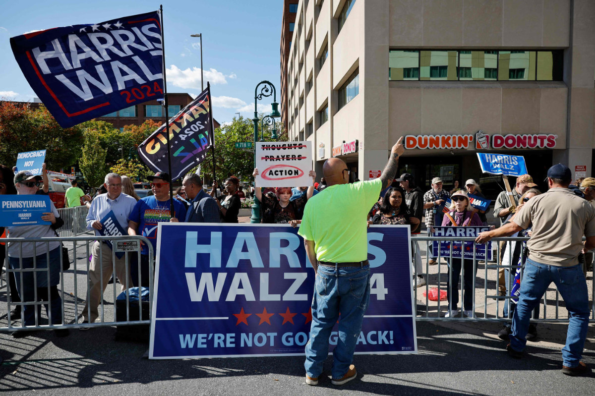 Municipal workers place barricades in front of supporters of Democratic presidential candidate Kamala Harris as they gather outside a campaign rally for Republican presidential candidate Donald Trump near the Santander Arena on October 09, 2024 in Reading, Pennsylvania. (Getty Images/AFP)