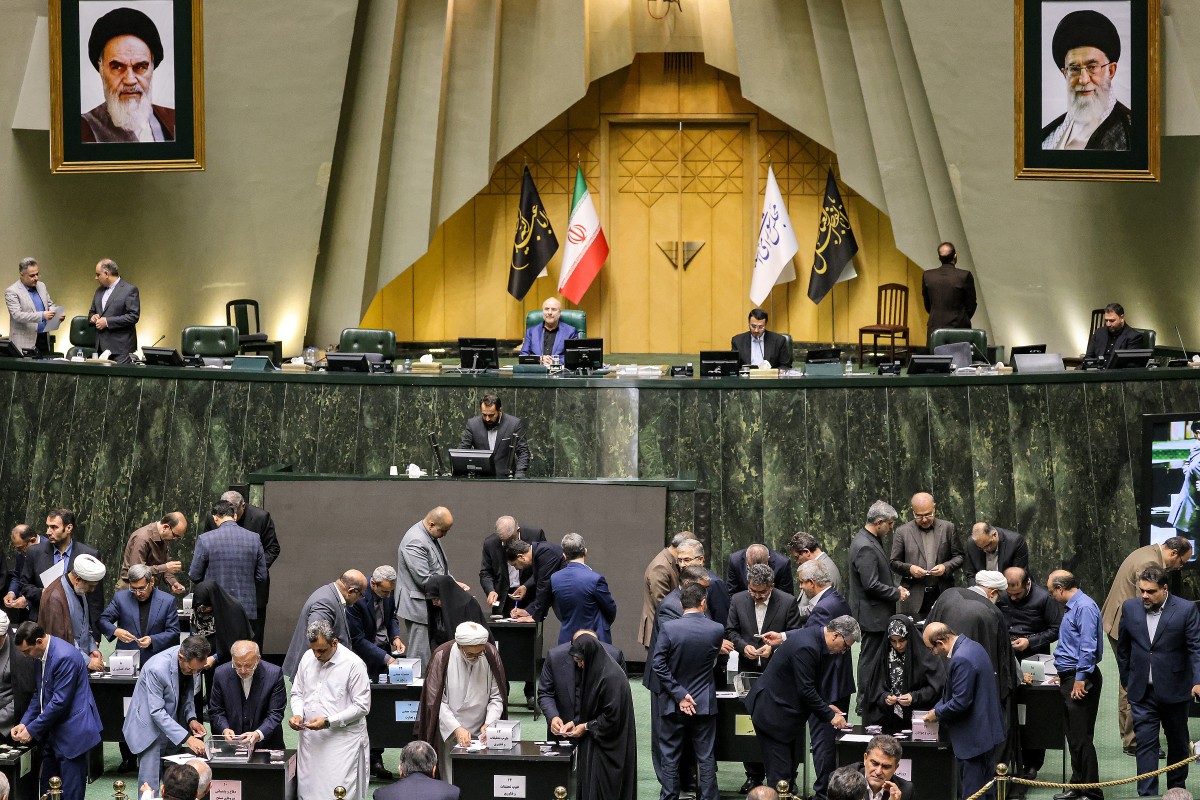 File photo Members of the Iranian parliament vote on the cabinet appointments proposed by the newly-elected president after an address during a special session in Tehran on August 21, 2024 (AFP)