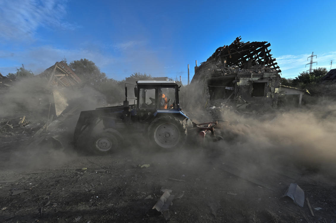 A municipal worker cleans a residential area which was hit by a Russian air strike, amid Russia's attack on Ukraine, in Zaporizhzhia, Ukraine (REUTERS)