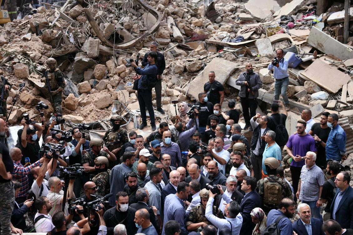 Iran’s parliament speaker Mohammad Bagher Ghalibaf, surrounded by members of the media, visits the site of an Israeli airstrike that targeted Beirut’s Basta neighborhood on Oct. 12, 2024. (AFP)