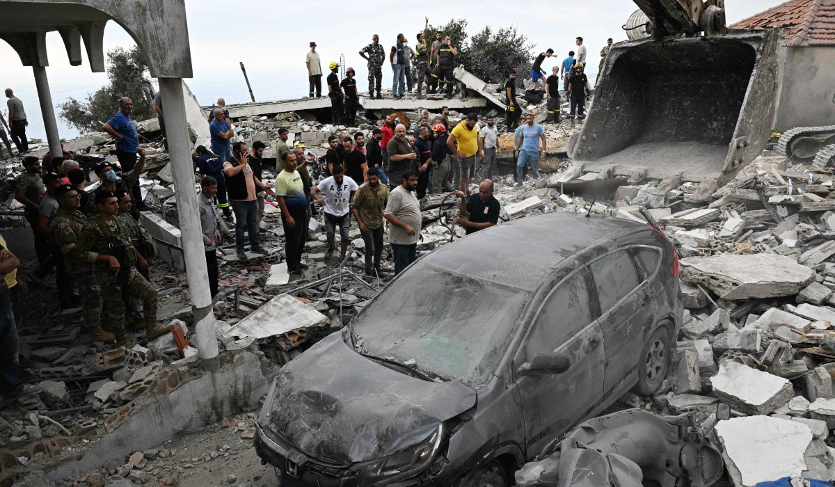 People inspect the damage at the site of an Israeli airstrike on the Mount Lebanon village of Maaysra, east of the coastal town of Byblos, on October 12, 2024. (AFP)
