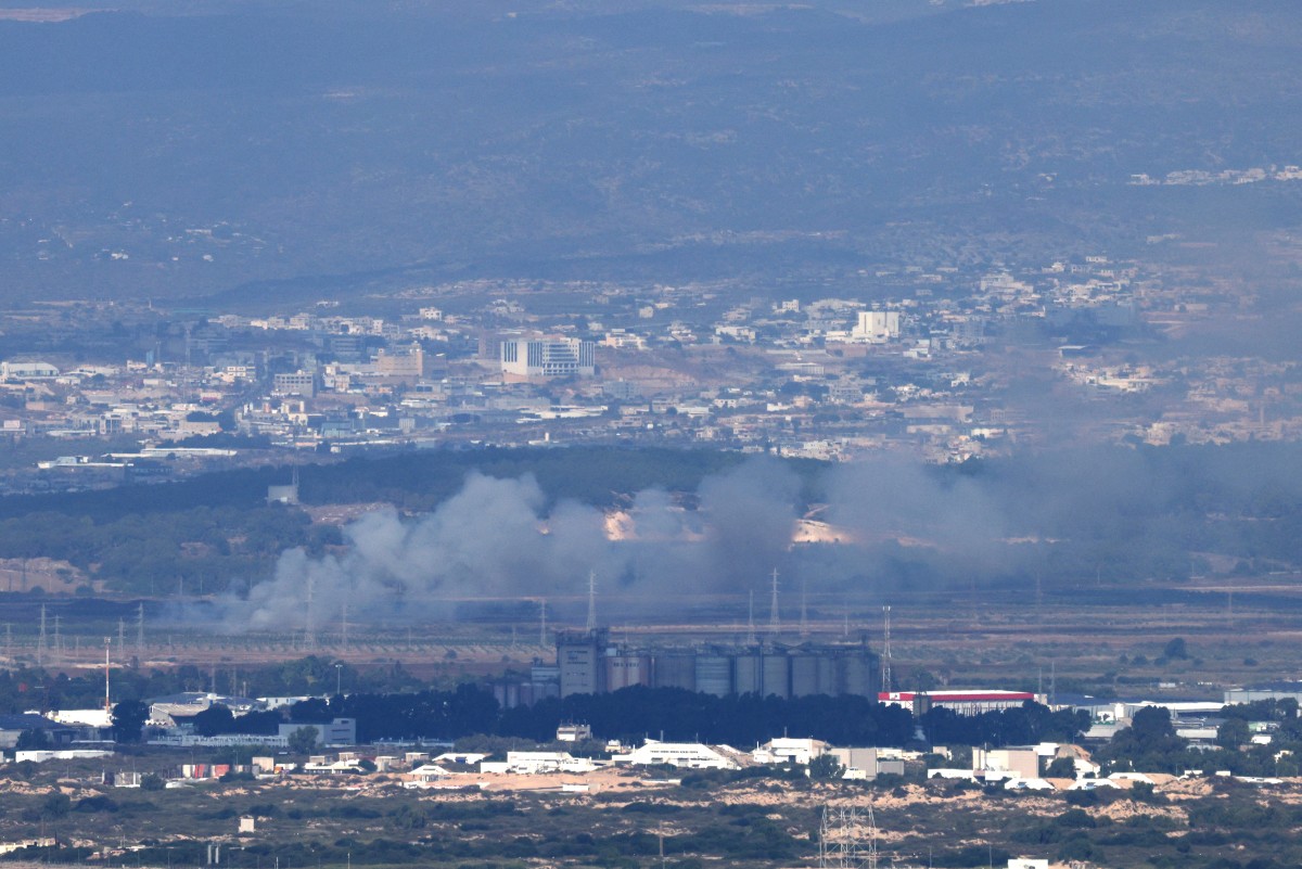 his picture taken from the northern Israeli port city of Haifa shows smoke billowing near the northern Israeli city of Tamra during a rocket attack from southern Lebanon on October 12, 2024. (AFP)
