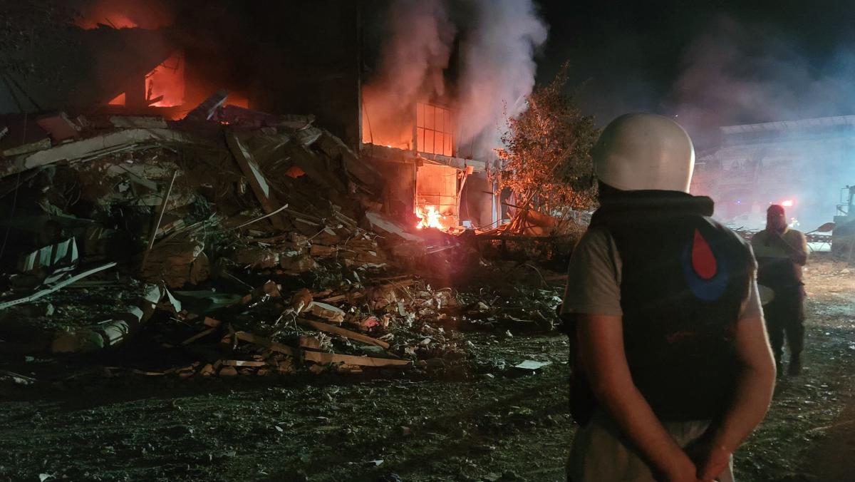 A person stands by damages at the site of an Israeli airstrike that targeted the southern Lebanese city of Nabatiyeh on October 12, 2024. (AFP)