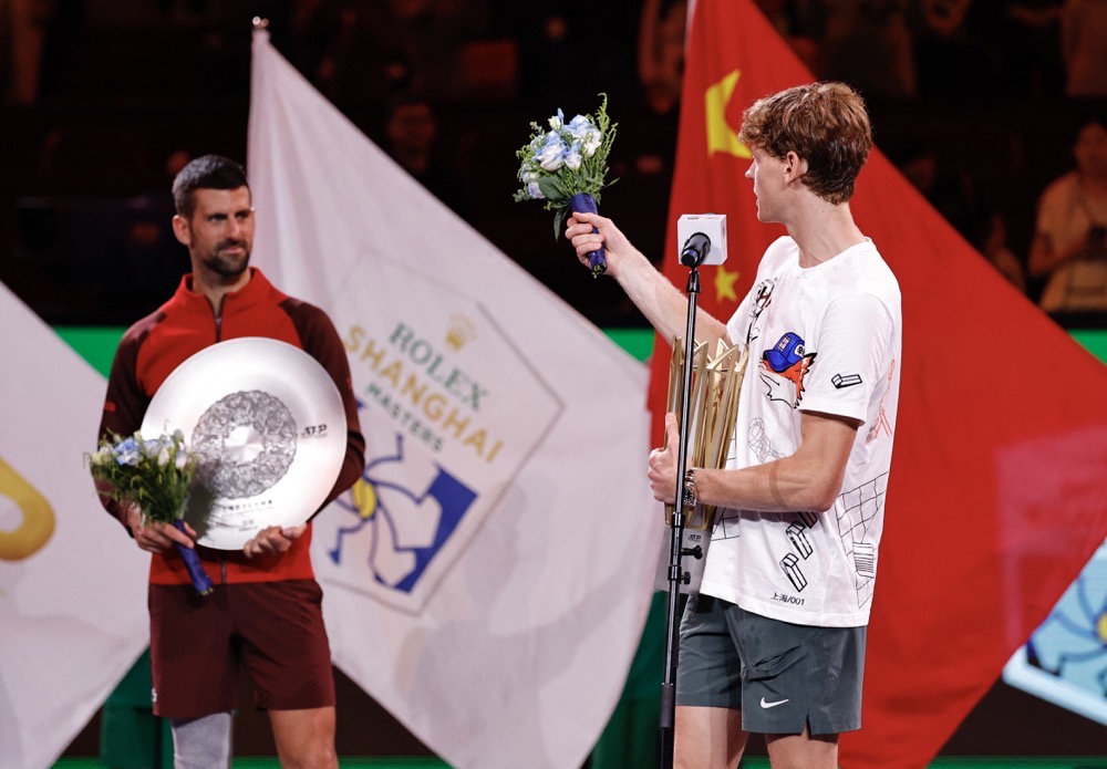 Italy's Jannik Sinner gives a speech with the trophy after winning his final match as Serbia's Novak Djokovic. (Reuters)