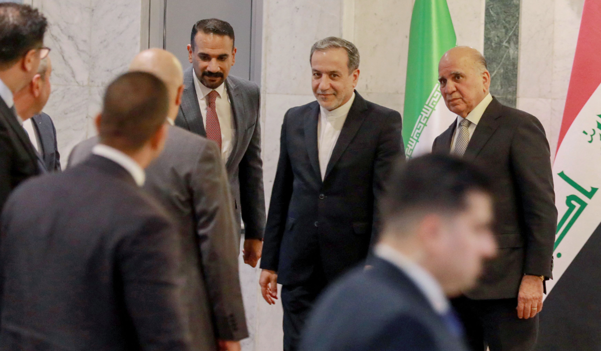 raqi Foreign Minister Fuad Hussein (R) welcomes his Iranian counterpart Seyed Abbas Araghchi (C) in Baghdad on October 13, 2024. (AFP)