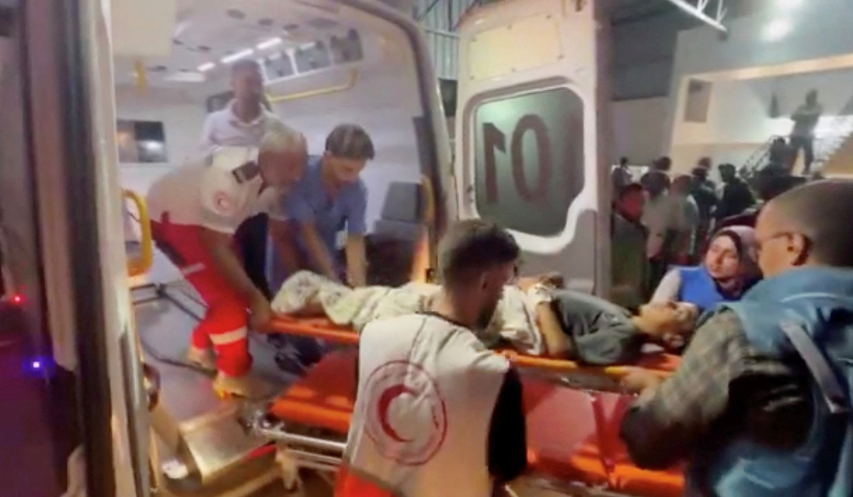 Members of the Palestine Red Crescent Society assist a Palestinian person on a stretcher, during the evacuation of people from Kamal Adwan Hospital in northern Gaza to Al-Shifa Hospital in Gaza City, at Al-Shifa Hospital in Gaza City, in this screen grab taken from a handout video released on October 12, 2024. (REUTERS)