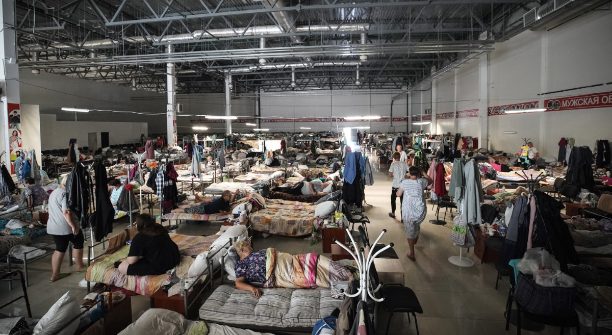 Russians fleeing from a cross-border offensive by Ukrainian forces into Kursk region idle their time away at an undisclosed evacuation center on on August 29, 2024. (AFP/File)