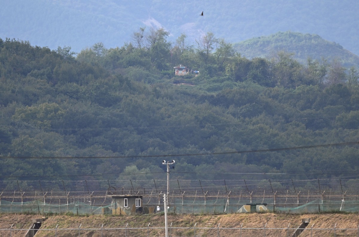 A North Korean guard post (top) on the North side of the Demilitarised Zone (DMZ) dividing the two Koreas, is seen over a South Korean guard post (bottom) from the border city of Paju on October 9, 2024 (AFP)