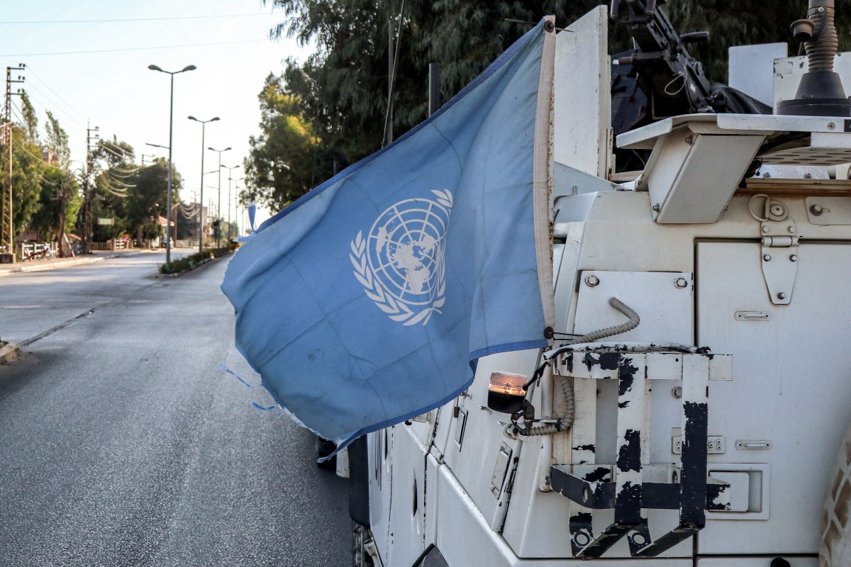 A United Nations flag flies in the back of one of the armoured vehicles of the UN Interim Force in Lebanon (UNIFIL) during a patrol around Marjayoun in south Lebanon (AFP)