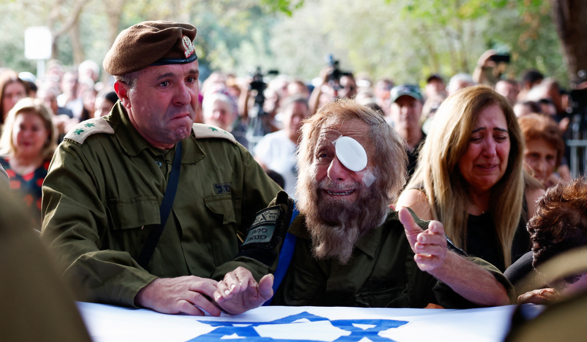 People mourn Israeli soldier Sergeant Amitai Alon, who was killed in a drone attack from Lebanon which Hezbollah claimed responsibility for, amid cross-border hostilities between Hezbollah and Israel, during his funeral in Agamon Hula, northern Israel, October 14, 2024. (REUTERS)