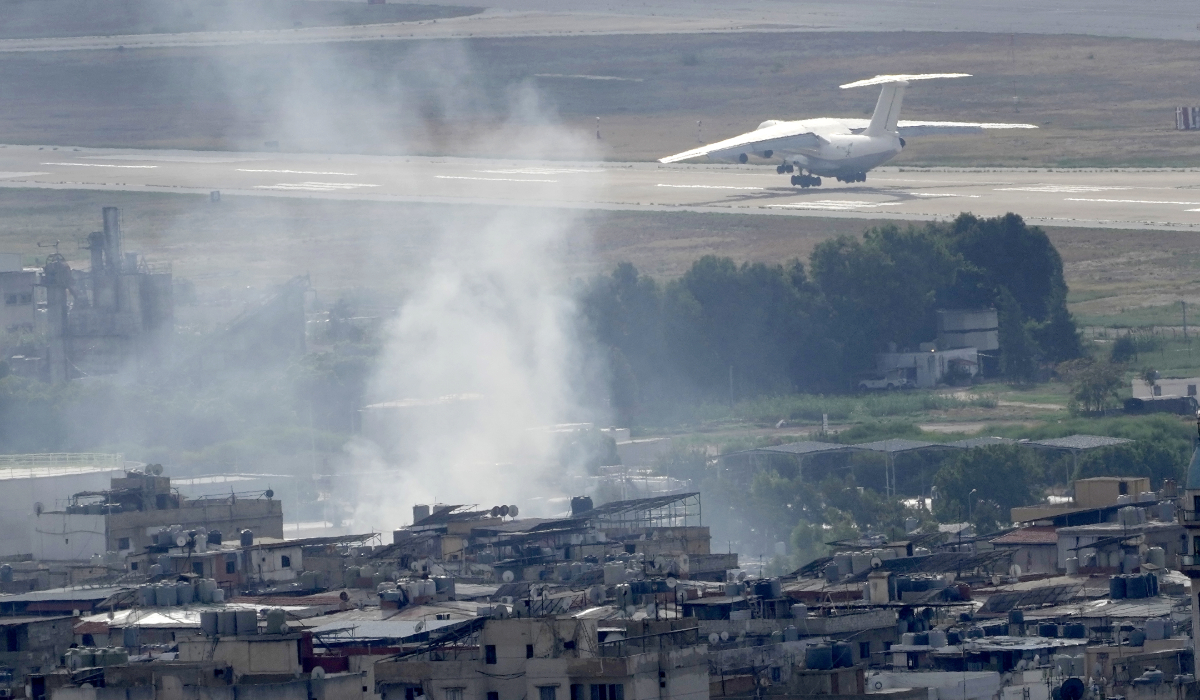 A plane take off from Rafik Hariri international airport as smoke of a past Israeli airstrike still rise from Dahiyeh, in Beirut, Lebanon, Monday, Oct. 14, 2024. (AP)